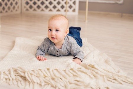 Beautiful smiling cute baby boy with motherの写真素材