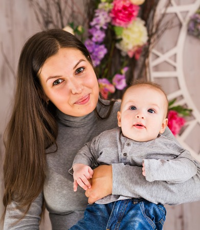 happy family. mother playing with her baby in the bedroom.の写真素材