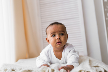 3-month old African American baby boy lay on the chair.