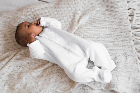 3-month old African American baby boy lay on the chair.