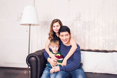 Beautiful family portrait relaxing at the living room at home.の写真素材