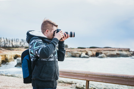 Young photographer on the beachの写真素材