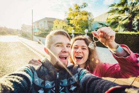 Happy couple showing their new house keys