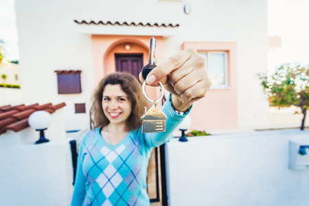 Beautiful caucasian woman holding keys of new houseの写真素材