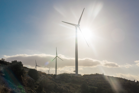 Green renewable energy concept - wind generator turbines in sky