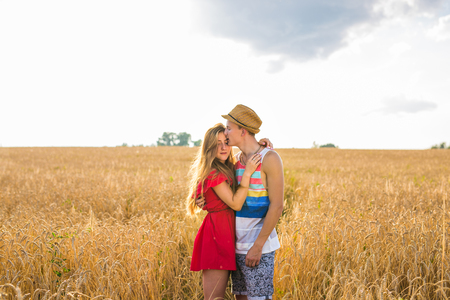 Young couple in love outdoor.Stunning sensual outdoor portrait of young stylish fashion couple posing in summer in field.の写真素材
