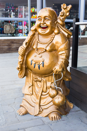 Smiling Buddha - Chinese God of Happiness, Wealth and Lucky on backgroundの写真素材