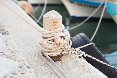 Wooden post with mooring ropes for tying boats and shipsの写真素材