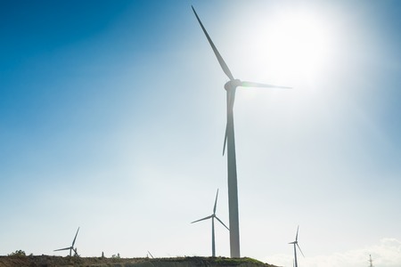 Wind turbine generating electricity with blue sky - energy conservation concept