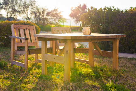 Wooden outdoor furniture. Lounge chairs in hotel garden invite you to relaxの写真素材