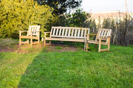 Wooden outdoor furniture. Lounge chairs in hotel garden invite you to relax