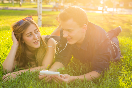 Couple listening to music on headphonesの写真素材