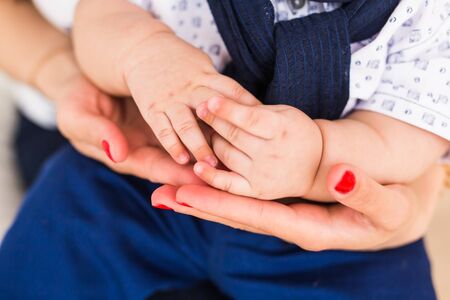Concept of love and family. Hands of mother and baby closeupの写真素材