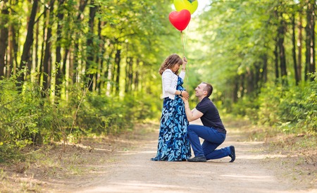 Caucasian pregnant woman and her husband outdoorsの写真素材