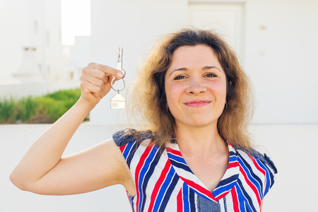 Close-up of happy house owner or renter showing keys and looking at youの写真素材