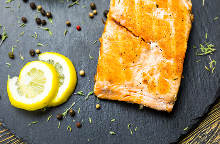 Grilled salmon steak with fresh lemon top viewの写真素材