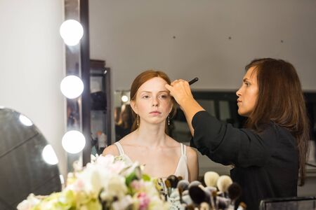 Make-up artist in the studio doing makeup beauty girlの写真素材