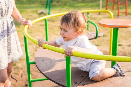 Cute young child boy or kid playing on playground.の写真素材