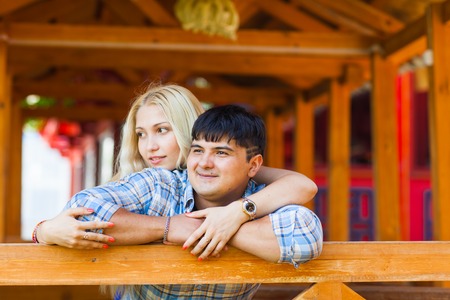Happy loving couple. Portrait of beautiful young couple bonding to each other and smiling while both standing outdoorsの写真素材