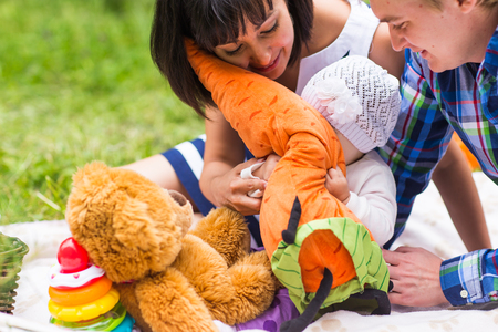 Happy family at picnic on the summer meadowの写真素材