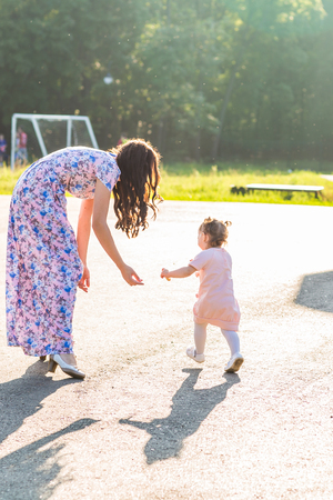 Happy cheerful family. Mother and baby have fun in nature outdoorsの写真素材