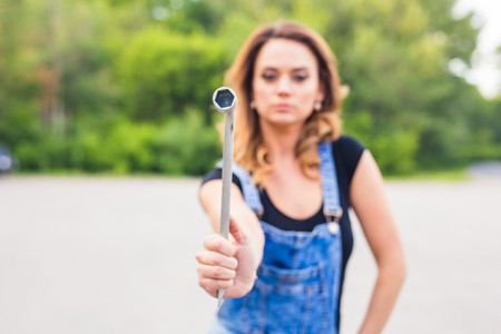 beautiful young woman repairing the carの写真素材