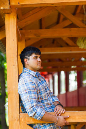 handsome mixed race young man smiling outdoorsの写真素材
