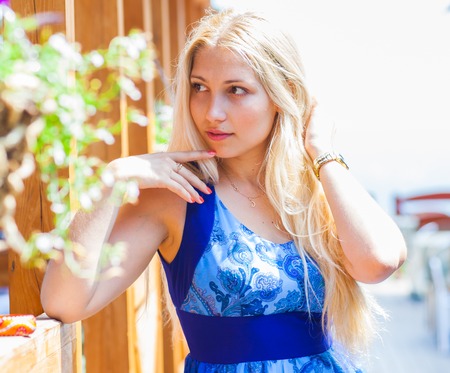 Summer girl portrait. Beautiful blonde woman smiling on sunny summer or spring dayの写真素材