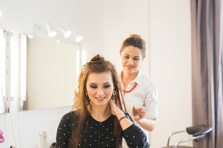 Hairdresser doing haircut for women in hairdressing salon. Concept of fashion and beauty. Positive emotion.の写真素材