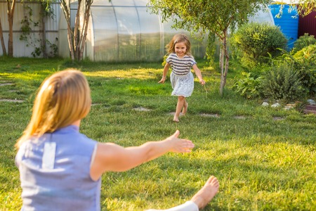 Portrait of happy loving mother and her baby outdoorsの写真素材