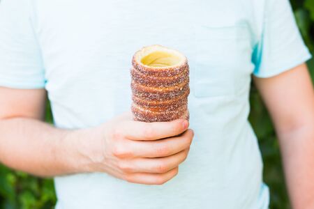 Trdelnik or trdlo in hand, national desert in Czech Republic.の写真素材