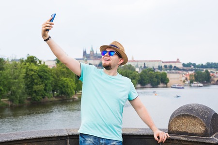Handsome man is taking a selfie outdoor - caucasian people - nature, people, lifestyle and technology concept.の写真素材