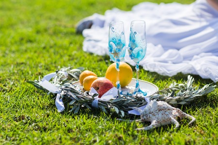 Two blue glasses for champagne on the grass. Wedding accessoriesの写真素材