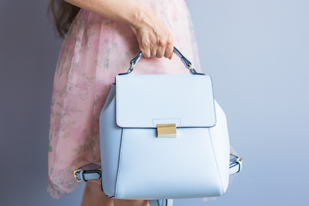 Close up stylish woman in pink skirt with blue bag. Fashion concept.の写真素材