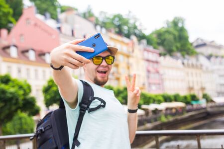 Handsome man is taking a selfie outdoor - caucasian people - nature, people, lifestyle and technology concept.の写真素材