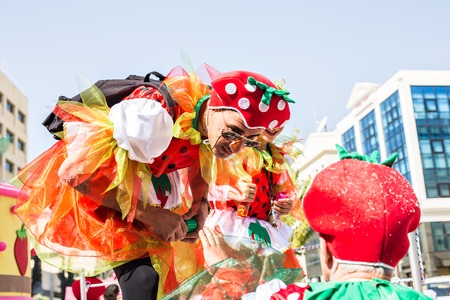 LIMASSOL, CYPRUS - FEBRUARY 26: Carnivalists in a silver cylinder hats joyfully follow the Limassol Municipality Band during the annual Carnival Parade, February 26, 2017 in Limassolのeditorial素材