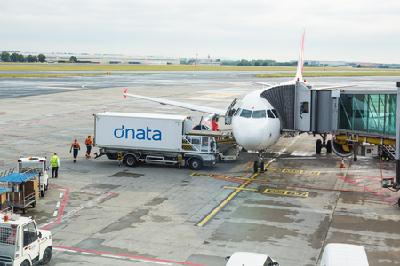 PRAGUE, CZECH REPUBLIC - JUNE 16, 2017: Vaclav Havel Prague International Airport, Ruzyne, Czech Republic. Personnel loading luggage into a plane in an airport.のeditorial素材