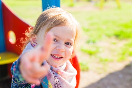 happy child girl showing thumbs upの写真素材