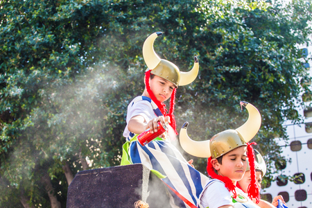 LIMASSOL, CYPRUS - FEBRUARY 26: Carnivalists in a silver cylinder hats joyfully follow the Limassol Municipality Band during the annual Carnival Parade, February 26, 2017 in Limassolのeditorial素材