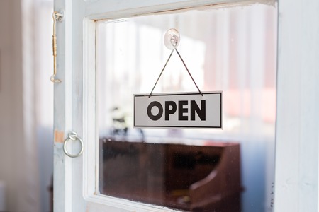 Open sign hanging in a shop window.の写真素材