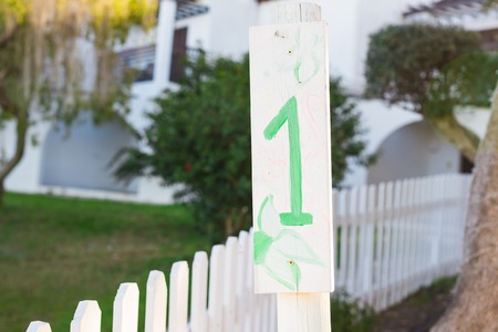 Number one 1 painted on wooden signboard.の写真素材