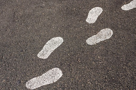 Painted footprints on the pavement