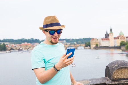 Young hipster man using mobile smart phone outdoorの写真素材