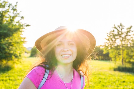 Close up portrait on cute funny laughing or surprised woman with freckles in hatの写真素材