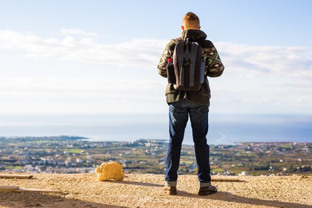 Close up portrait of a happy young man traveling with backpack.の写真素材