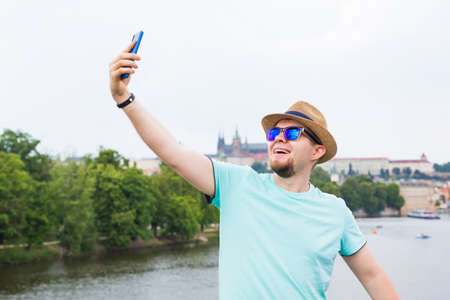 Handsome man is taking a selfie outdoor - caucasian people - nature, people, lifestyle and technology concept.の写真素材
