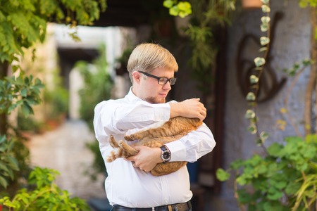 Red cat in the hands of stylish manの写真素材