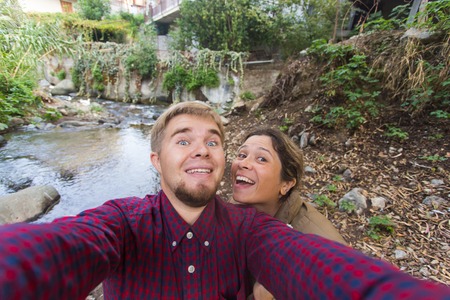 Loving cheerful happy couple taking selfie in the city