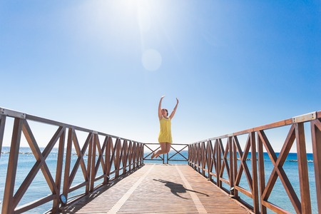 happy young woman have fun on the beach of seaの写真素材