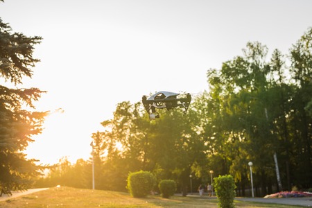 White drone, quadrocopter with photo camera flyingの写真素材